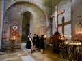 Women offering candles and praying inside Svetitskhoveli Cathedral, Mtskheta, Georgia, 27.07.2022. Royalty Free Stock Photo