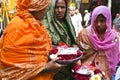 women offering flowers in Muslim shrine