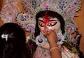 A women offering sweets to goddess Saraswati