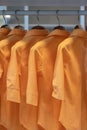 Orange colors shirts hang in a wooden closet at modern home decoration Royalty Free Stock Photo