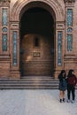 Women outside Torre Notte, North Tower on Plaza de Espana, Seville, Spain