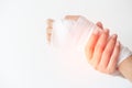 Women with painful wrist due to overuse or sport accidental on white background, Hand of girl strapping with bandage and Cure