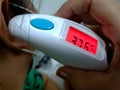 Women patient checking temperature by ear digital thermometer Royalty Free Stock Photo