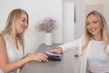 A woman pays using a non -contact payment of the NFC used by a smartphone.