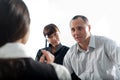 Women with pen and men with girl in black jacket Royalty Free Stock Photo