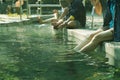 Women and people stretch their legs and feet soaked in hot mineral spring water. Health and relaxation activities at Sankampang Royalty Free Stock Photo