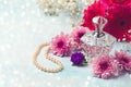 Women perfume bottle and pearl necklace