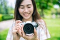 Women photographer hold camera enjoy taking a photo outdoor hobby happy smile