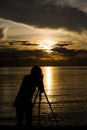 Women photographer Sunrise At the beach Royalty Free Stock Photo