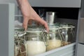 Women picking an item from storage hutch. Smart kitchen organization concept Royalty Free Stock Photo