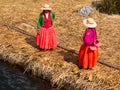 Women on pier in Reed Islands on Lake Titicaca, 6/13/13 Royalty Free Stock Photo