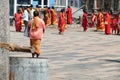 Women pilgrims wear red sarees in the Shiva Nataraja temple