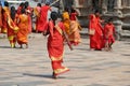 Women pilgrims wear red sarees in the Shiva Nataraja temple