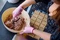 Women with pink gloves preparing homemade cake