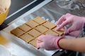 Women with pink gloves preparing homemade cake,