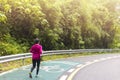 Women with pink long sleeve runing on road in morning time