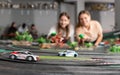 women players playing with slot car racing track Royalty Free Stock Photo