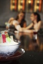 Women playing cards on the bar counter, focus on cocktails. Conceptual image Royalty Free Stock Photo