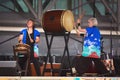 Women playing taiko, or traditional Japanese drums