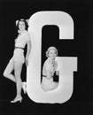 Women posing with huge letter G Royalty Free Stock Photo