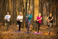 Women practicing yoga in autumn park, Ukraine. Chernihiv