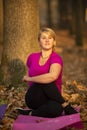 Women practicing yoga in autumn park, Ukraine. Chernihiv