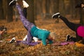 Women practicing yoga in autumn park, Ukraine. Chernihiv