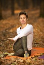 Women practicing yoga in autumn park, Ukraine. Chernihiv