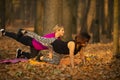 Women practicing yoga in autumn park, Ukraine. Chernihiv