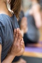 Women practicing yoga: reverse prayer pose