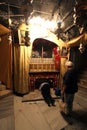 Women pray at the silver star marks the traditional site of Jesus` birth in a grotto underneath Bethlehem`s Church of the Nativity Royalty Free Stock Photo