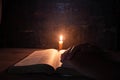 Women praying on the Bible in the light candles selective focus Royalty Free Stock Photo