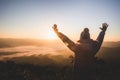 Women praying at sunset mountains raised hands Travel Lifestyle spiritual relaxation emotional concept, Freedom and travel Royalty Free Stock Photo