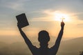 A women is praying to God on the mountain. Praying hands with faith in religion and belief in God on blessing background. Power of Royalty Free Stock Photo