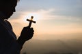 A women is praying to God on the mountain. Praying hands with faith in religion and belief in God on blessing background. Power of Royalty Free Stock Photo