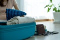 Women are preparing clothes and passports, various belongings, travel ingress in the bedroom. Women plan holiday travel trips
