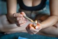 Women preparing lighting up marijuana joint with lighter. cannabis smoker rolling marijuana cannabis joint. Drugs narcotic concept