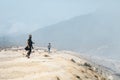 Women in protective filter mask walking around Ijen volcano crater