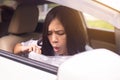 Woman puke or vomiting into plastic bag in car,Car Sick and motion sickness Royalty Free Stock Photo