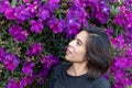 Women and Purple flower or Tibouchina granulosa in garden.