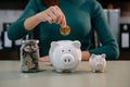 Women are putting coins in a piggy bank for a business that grows for profit and saving money for the future. planning for Royalty Free Stock Photo