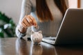 Women are putting coins in a piggy bank for a business that grows for profit and saving money for the future. planning for Royalty Free Stock Photo