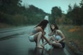 Women quarrel in rain on the road.