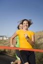 Women racing to finish line Royalty Free Stock Photo