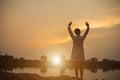 Women raise arms to watch the sunset