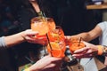 Women raising a glasses of aperol spritz at the dinner table. Royalty Free Stock Photo