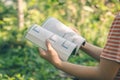 Women read holiday book in nature quiet environment