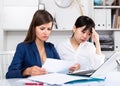 Women reading documents with upset faces at office Royalty Free Stock Photo