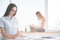 Women reading in office Royalty Free Stock Photo