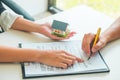 Women Real Estate Agent showing where to sign on document for bu Royalty Free Stock Photo